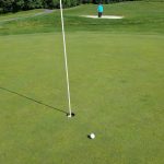 green grass with the flag in the hole.