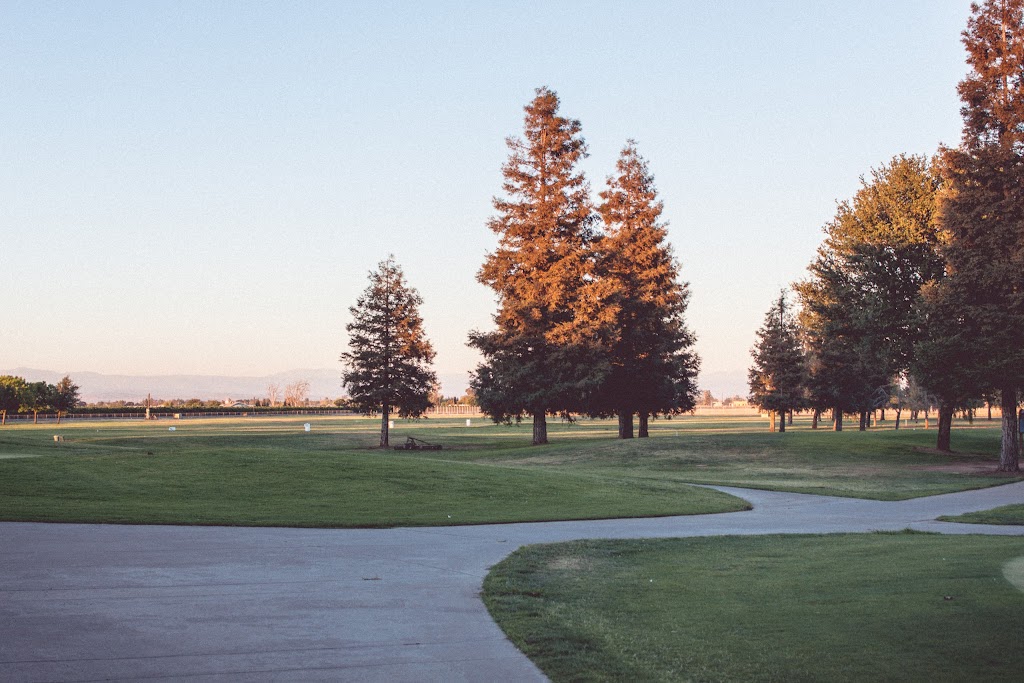 Panoramic view of a lush green golf course at Madera Municipal Golf Course. Smooth