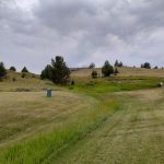 Panoramic view of a lush green golf course at Madison Meadows Golf Course. Smooth