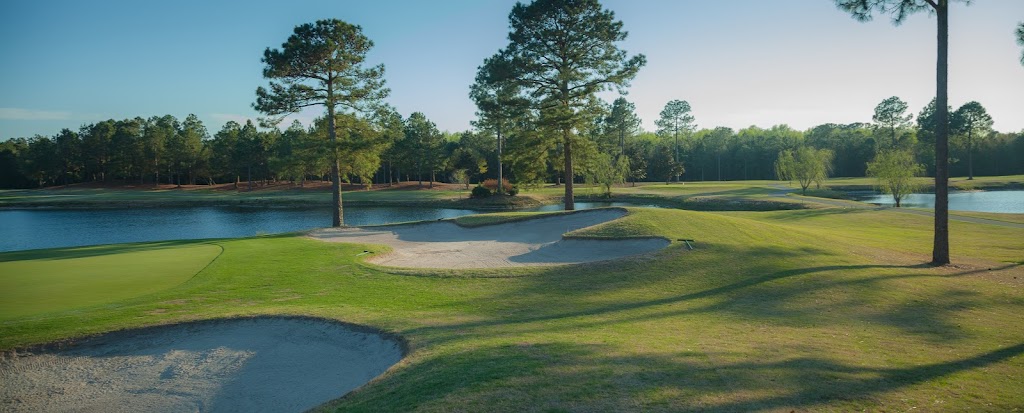 Panoramic view of a lush green golf course at Magnolia Greens Golf Course. Smooth