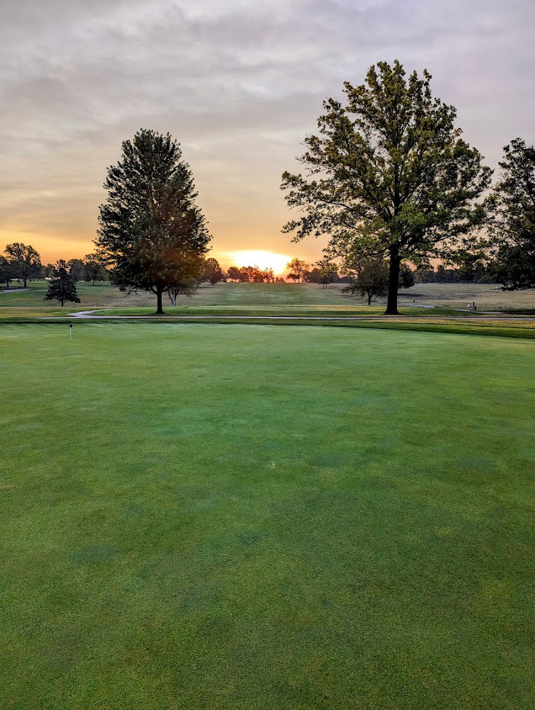Panoramic view of a lush green golf course at Mahoney Golf Course. Smooth