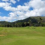 Panoramic view of a lush green golf course at Makaha Valley Country Club. Smooth