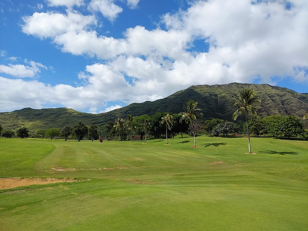 Panoramic view of a lush green golf course at Makaha Valley Country Club. Smooth
