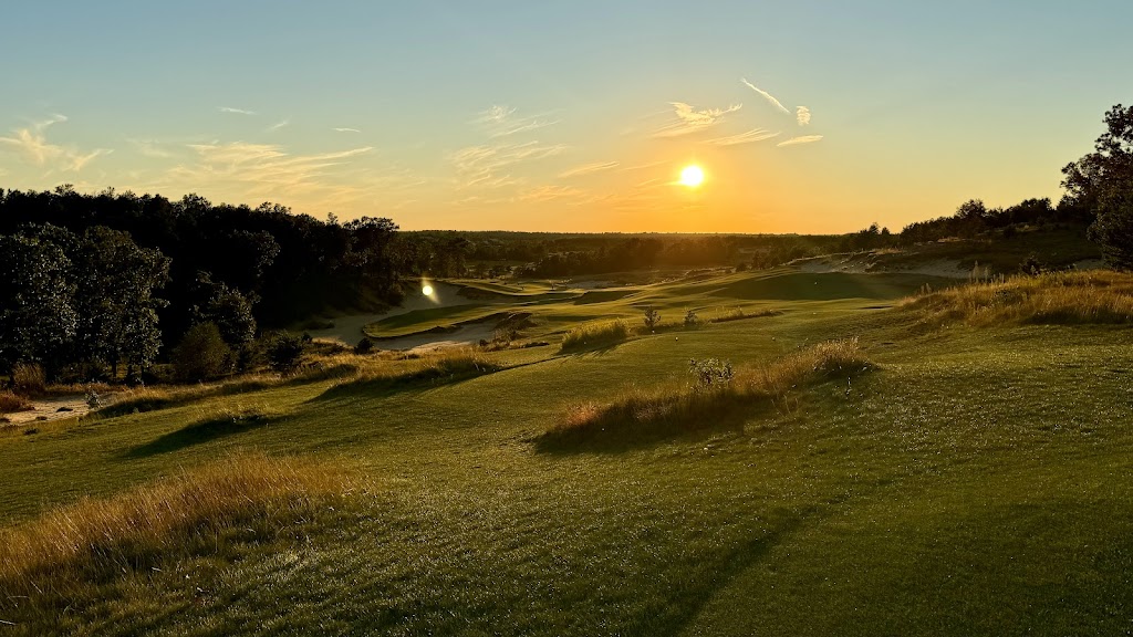 Panoramic view of a lush green golf course at Mammoth Dunes. Smooth