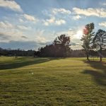 Panoramic view of a lush green golf course at Manchester Country Club. Smooth