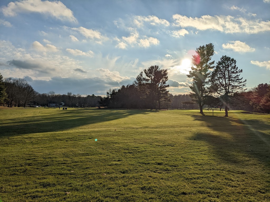 Panoramic view of a lush green golf course at Manchester Country Club. Smooth
