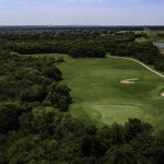 green grass with the flag in the hole.