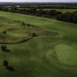 Panoramic view of a lush green golf course at Mansfield National Golf Club. Smooth