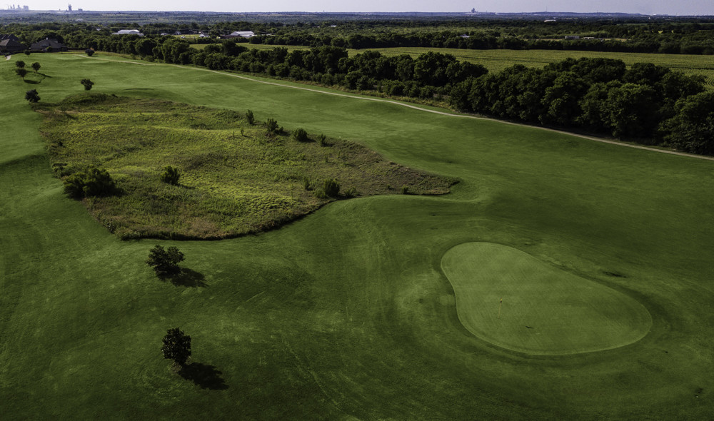Panoramic view of a lush green golf course at Mansfield National Golf Club. Smooth