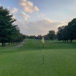 green grass with the flag in the hole.