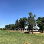 Panoramic view of a lush green golf course at Maple River Golf Club. Smooth