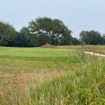 Panoramic view of a lush green golf course at Marine Park Golf Course. Smooth