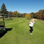 Panoramic view of a lush green golf course at Marquette Trails Golf Club. Smooth
