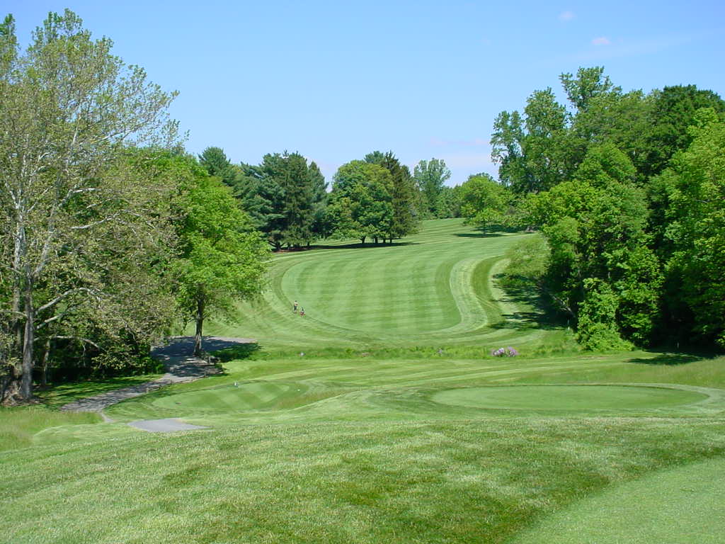 Panoramic view of a lush green golf course at Maryland Golf & Country Clubs. Smooth