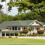 Panoramic view of a lush green golf course at Maui Country Club. Smooth
