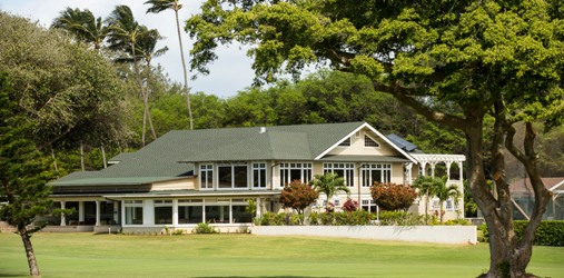 Panoramic view of a lush green golf course at Maui Country Club. Smooth