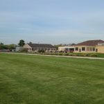 Panoramic view of a lush green golf course at Mayapple Golf. Smooth