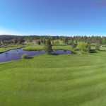 Panoramic view of a lush green golf course at McCall Golf Club. Smooth