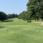 Panoramic view of a lush green golf course at McCann Memorial Golf Course. Smooth