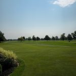 Panoramic view of a lush green golf course at McCormick Creek Golf Course. Smooth