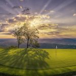 Panoramic view of a lush green golf course at McLemore Resort. Smooth