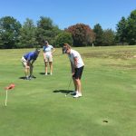 green grass with the flag in the hole.