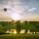 Panoramic view of a lush green golf course at Meadowcreek Golf Course. Smooth
