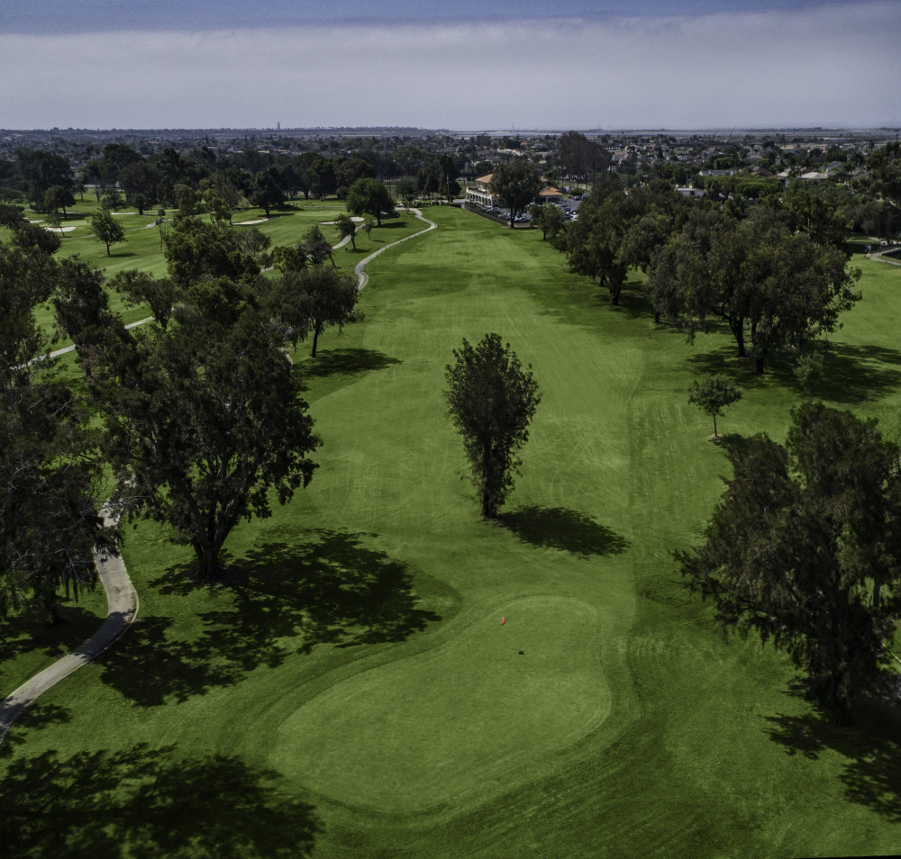 Panoramic view of a lush green golf course at Meadowlark Golf Club. Smooth