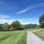 Panoramic view of a lush green golf course at Meadowlark Hills Golf Course. Smooth