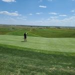 green grass with the flag in the hole.