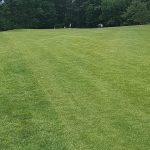 Panoramic view of a lush green golf course at Melody Hill Country Club. Smooth