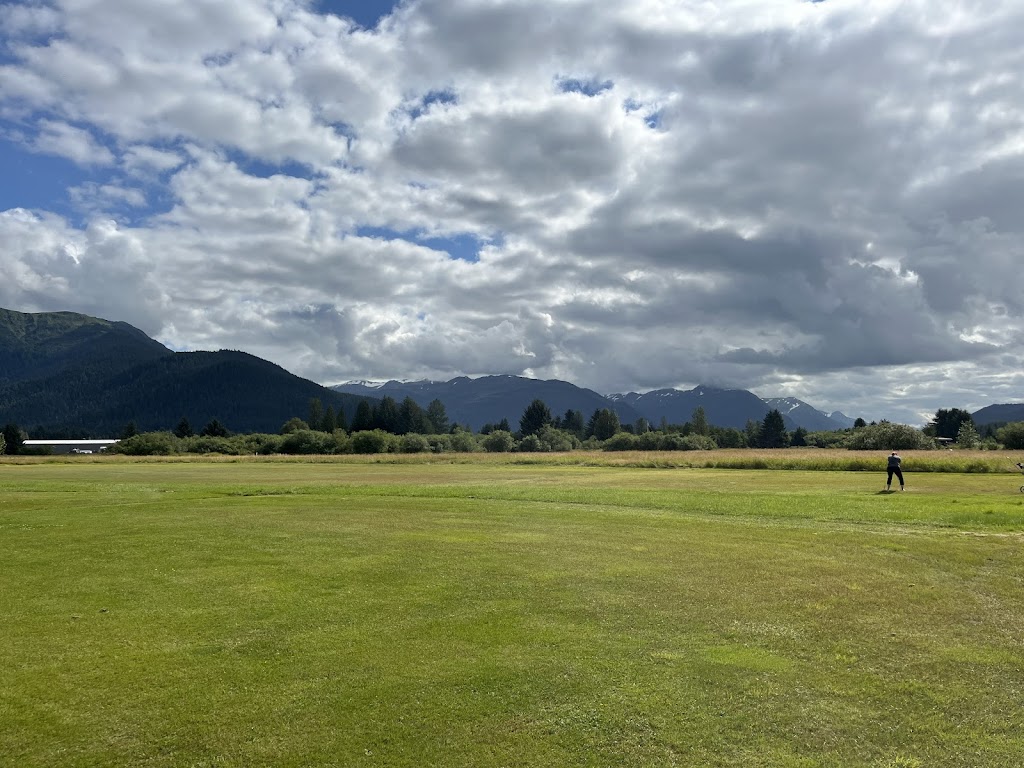 Panoramic view of a lush green golf course at Mendenhall Golf. Smooth