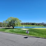 Panoramic view of a lush green golf course at Mercer Oaks Golf Course. Smooth
