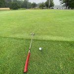 green grass with the flag in the hole.
