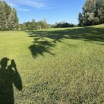 Panoramic view of a lush green golf course at Meriwether National Golf Club. Smooth