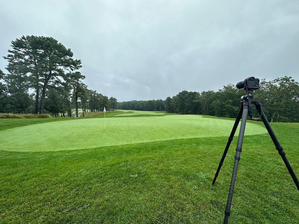 Panoramic view of a lush green golf course at Metedeconk National Golf Club. Smooth