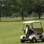 green grass with the flag in the hole.