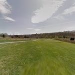 Panoramic view of a lush green golf course at Miami Whitewater Forest Golf Course. Smooth