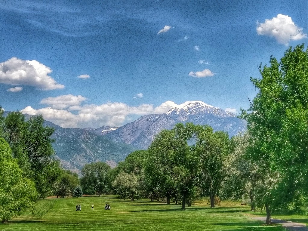 Panoramic view of a lush green golf course at Mick Riley Golf Course. Smooth