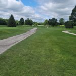 Panoramic view of a lush green golf course at Mill Creek Golf Club. Smooth