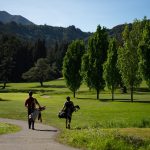 Panoramic view of a lush green golf course at Mill Valley Golf Course. Smooth