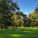 Panoramic view of a lush green golf course at Millburn Township Golf Course. Smooth