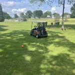 Panoramic view of a lush green golf course at Minibel Par 3 Golf Course. Smooth