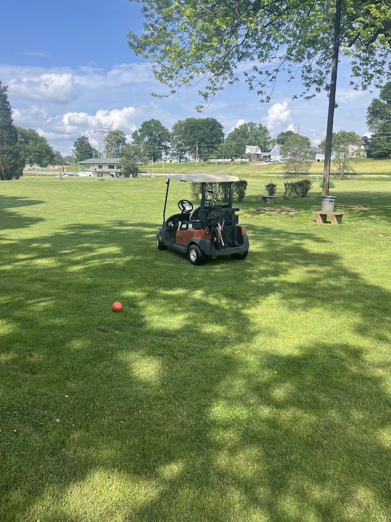 Panoramic view of a lush green golf course at Minibel Par 3 Golf Course. Smooth