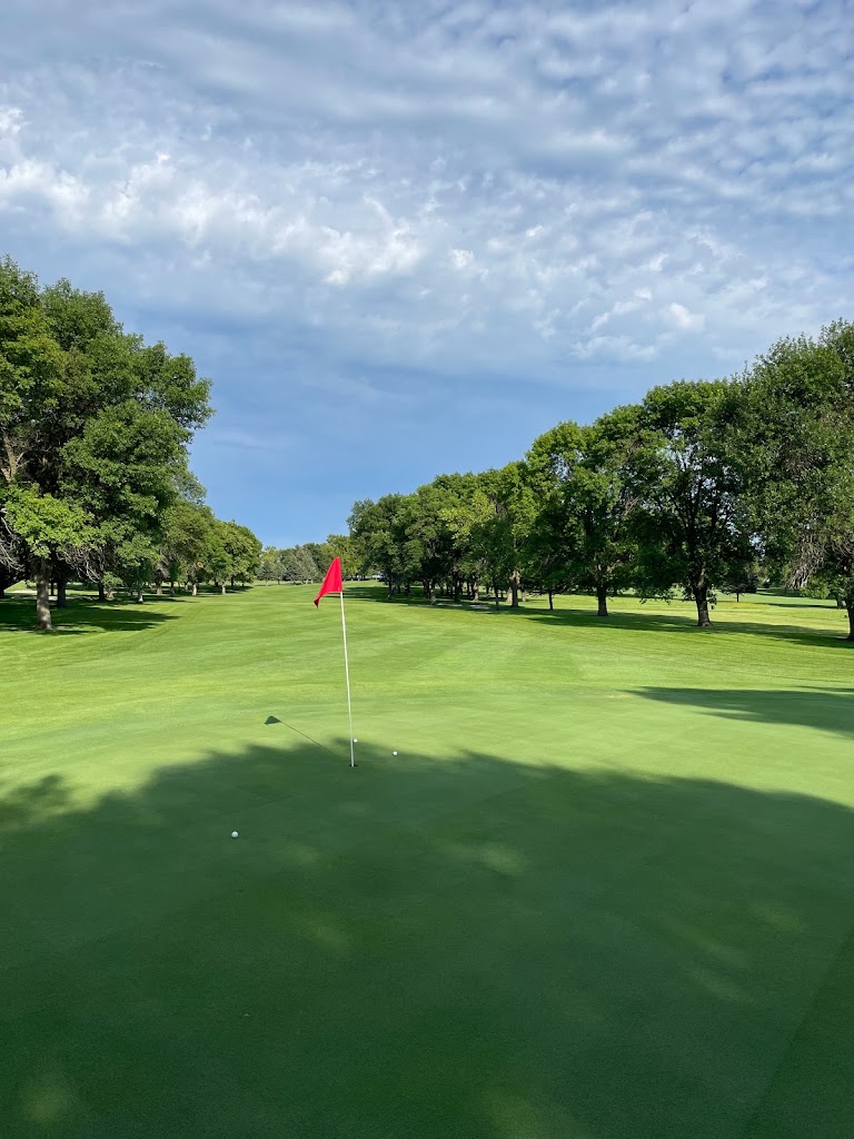 Panoramic view of a lush green golf course at Minn Iowa Golf Course. Smooth