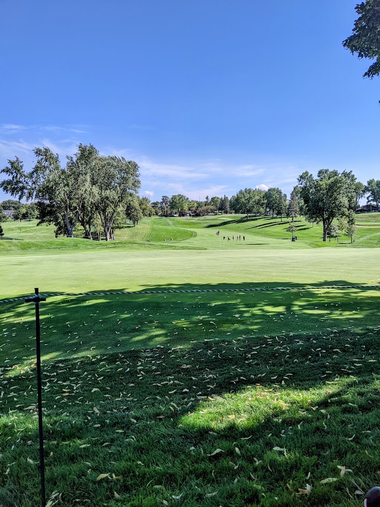 Panoramic view of a lush green golf course at Minnehaha Country Club. Smooth