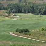 Panoramic view of a lush green golf course at Minot Country Club. Smooth