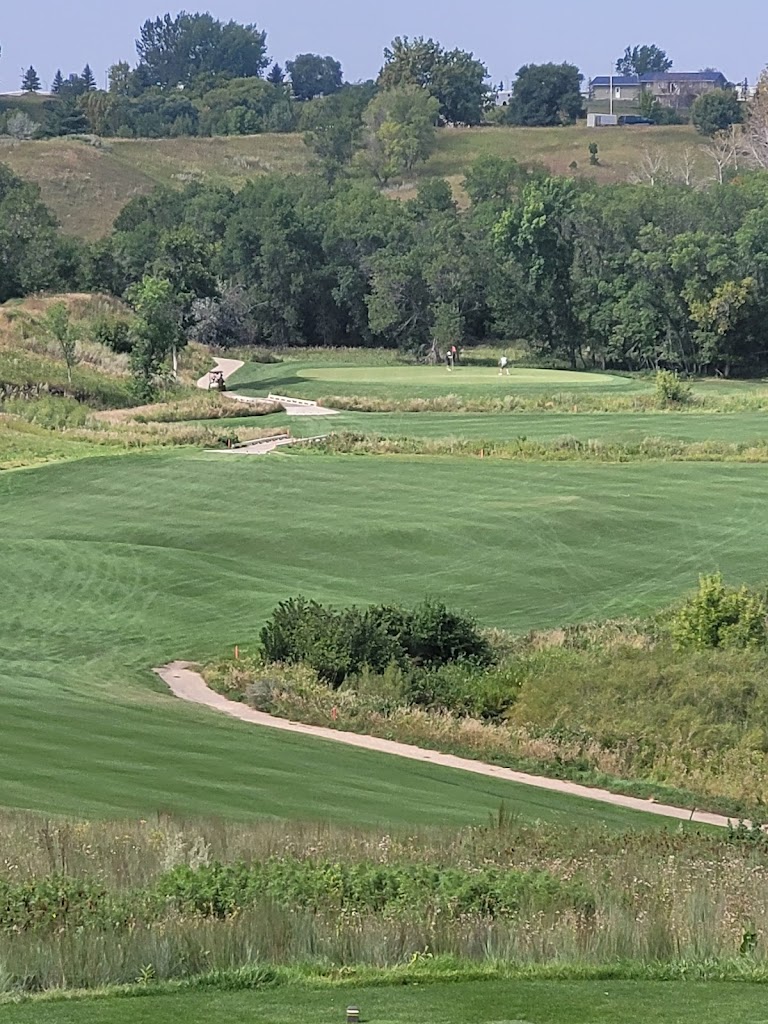 Panoramic view of a lush green golf course at Minot Country Club. Smooth