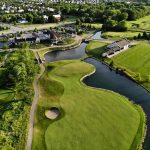 Panoramic view of a lush green golf course at Mistwood Golf Club. Smooth