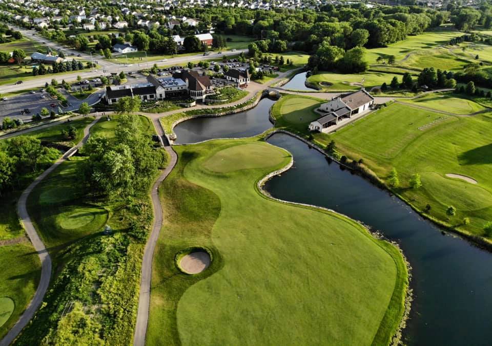 Panoramic view of a lush green golf course at Mistwood Golf Club. Smooth